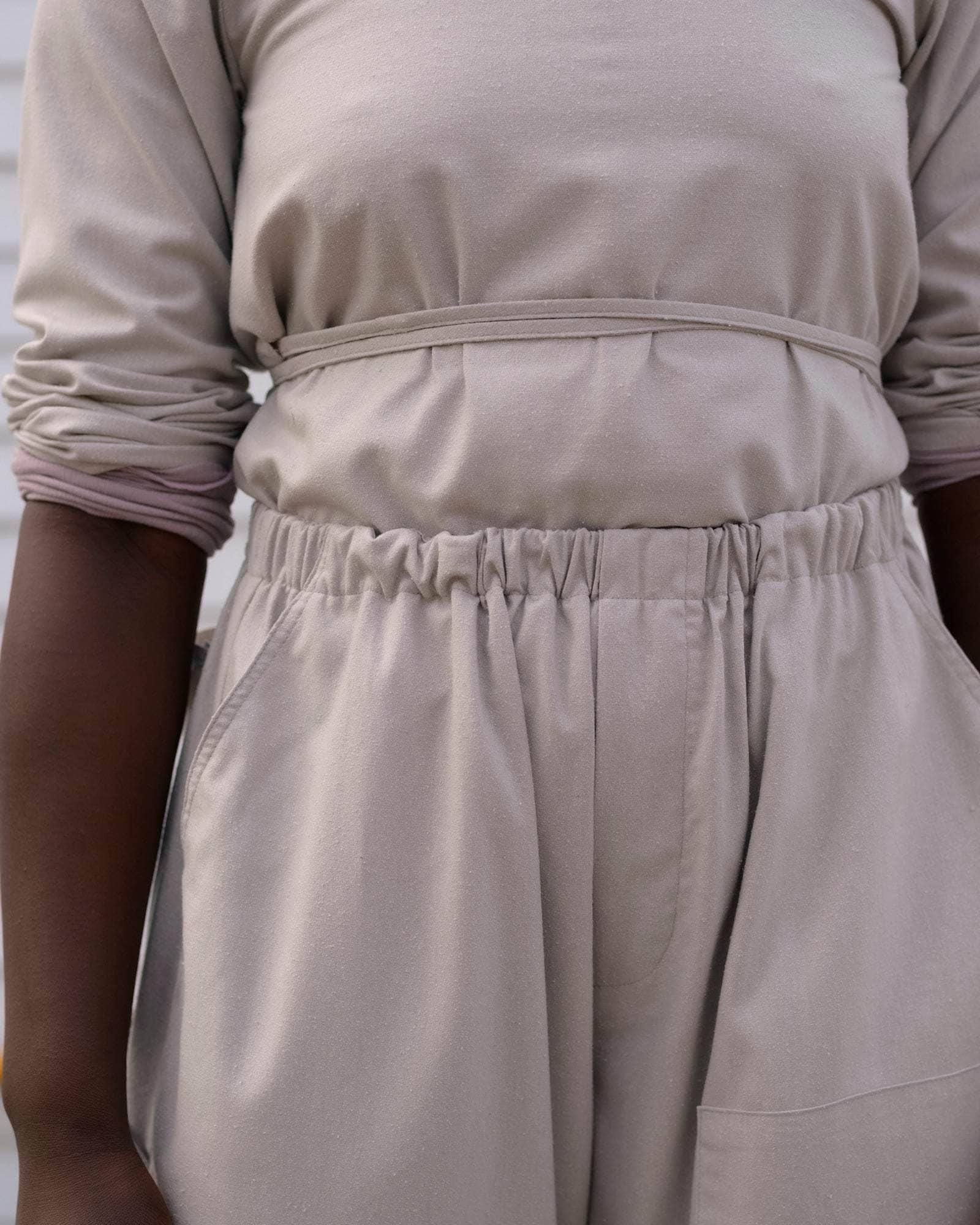 BASERANGE WOVEN LONG SLEEVE APRON TOP